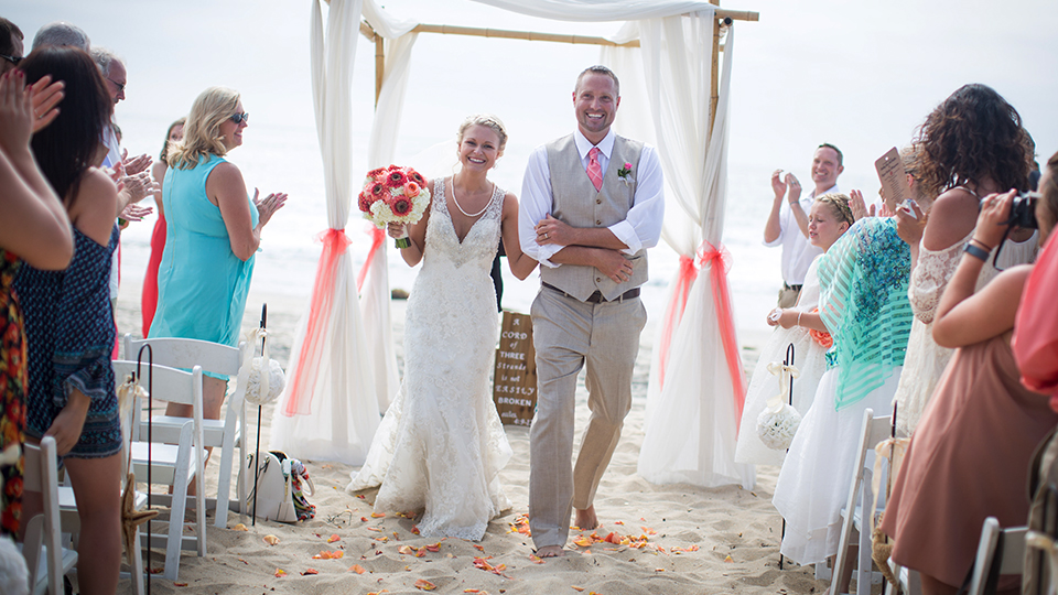 Newly-Married-Couple-Walking-Down-The-Aisle-After-Their-Beach-Wedding-Ceremony
