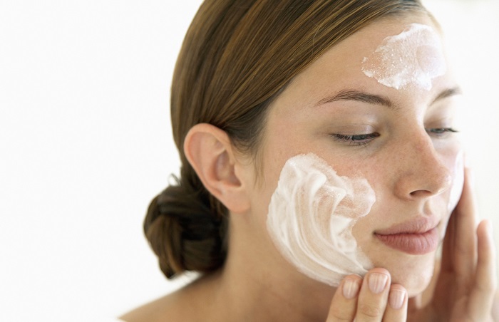 Young Woman Using Facial Cream